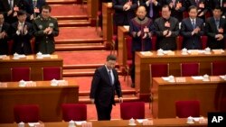 FILE - Chinese President Xi Jinping arrives for the closing session of the Chinese People's Political Consultative Conference (CPPCC) at the Great Hall of the People in Beijing, March 13, 2019.