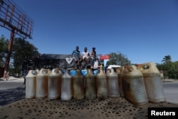 Containers filled with fuel that is sold on the black market are offered in a street in Port-au-Prince, Haiti, February 24, 2019.