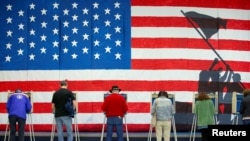 Voters cast their ballots to vote in state and local elections at Robious Elementary School in Midlothian, a suburb of Richmond, Virginia, U.S. November 5, 2019. REUTERS/Ryan M. Kelly - RC11256D2610