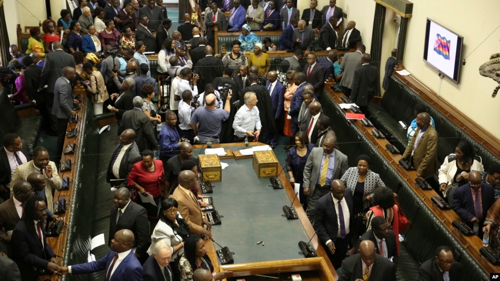 FILE: Members of the House of Assembly sit inside the Zimbabwean Parliament in Harare, Nov. 21 2017. AP Photo/Aaron Ufumeli)