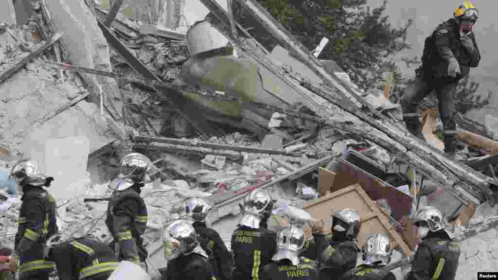 French firefighters search the rubble of a collapsed building in Rosny-Sous-Bois, near Paris, Aug. 31, 2014.