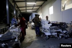 Patients and family members are seen outside the Institute for Social Security and Services for State Workers (ISSSTE) after an earthquake struck off the southern coast of Mexico late Thursday, in Puebla, Mexico, Sept. 8, 2017.