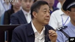 In this image taken from video, Chinese politician Bo Xilai looks up in a court room at Jinan Intermediate People's Court in Jinan, eastern China's Shandong province, Aug. 26, 2013.