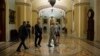 FILE - U.S. senators are seen leaving the Senate chamber on Capitol Hill, in Washington, May 31, 2015.