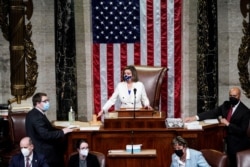 U.S. Speaker of the House Nancy Pelosi (D-CA) wields her gavel ahead of the final passage in the House of Representatives of U.S. President Joe Biden's $1.9 trillion coronavirus disease