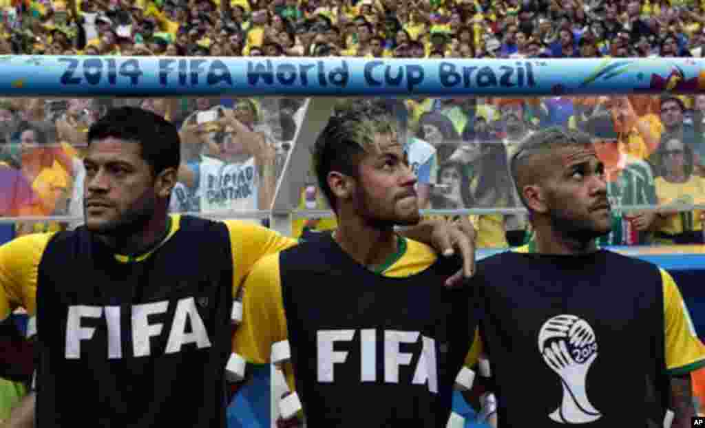 From left, Brazil's Hulk, Neymar and Dani Alves wait for the start of the World Cup third-place soccer match between Brazil and the Netherlands at the Estadio Nacional in Brasilia, Brazil, Saturday, July 12, 2014. (AP Photo/Andre Penner)