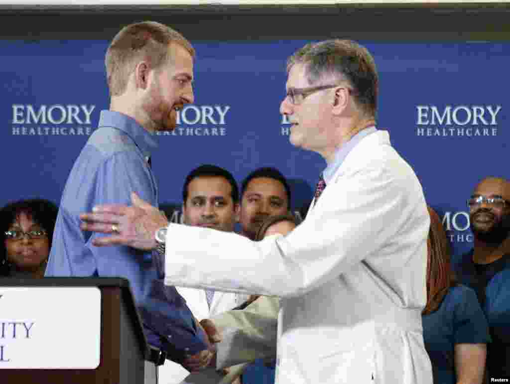 Kevin Brantly (left), who contracted the deadly Ebola virus, thanks Bruce Ribner, medical director of Emory&#39;s Infectious Disease Unit during a press conference at Emory University Hospital, in Atlanta, Georgia, Aug. 21, 2014.