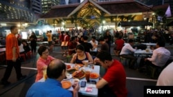 People eat at Lau Pa Sat food center in Singapore, July 29, 2016.