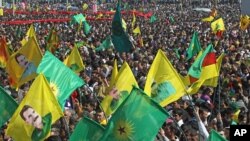 Thousands of PKK supporters demonstrate with flags and posters of jailed Kurdish rebel leader Abdullah Ocalan, in southeastern city of Diyarbakir, Turkey, March 21, 2013.