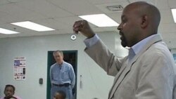 Teacher Fred Tenyke discusses science with the class at Georgian Forest Elementary school as retired engineer Dave Weiss, who helps apply his experience to help, looks on, in Silver Spring, Maryland, November 2011