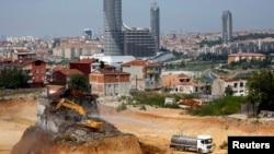 An excavator demolishes a lone house at the construction site of an urban transformation project in Fikirtepe, an Istanbul neighborhood in the Asian part of the city, Turkey, Aug. 14, 2014. 