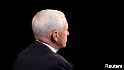 A fly is seen on the head of U.S. Vice President Mike Pence as he takes part in the 2020 vice presidential debate, October 7, 2020. 