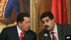 Venezuelan President Hugo Chavez, left, with his then Foreign Minister and current Vice President Nicolas Maduro, Miraflores Palace, Caracas (undated file photo).