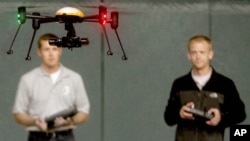 Students at John D. Odegard School of Aerospace Sciences at the University of North Dakota in Grand Forks, North Dakota, remotely pilot a drone during a demonstration, in a June 24, 2014, photo.
