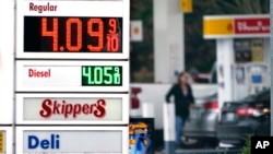 FILE - A driver fills a tank at a gas station in Marysville, Washington, Dec. 10, 2021. Consumer prices rose 6.8% for the 12 months ending in November, a 39-year high.