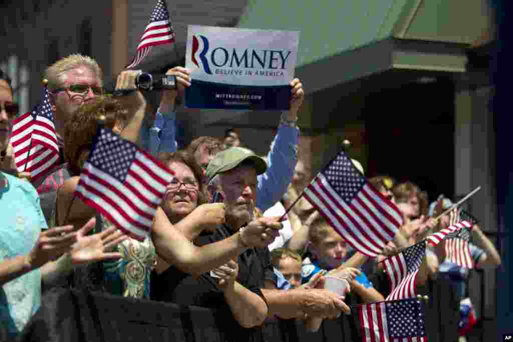 Supporters of Republican presidential candidate, former Massachusetts Gov. Mitt Romney watch him speak during a campaign stop at Sweetie-licious Bakery in DeWitt, Michigan, June 19, 2012.