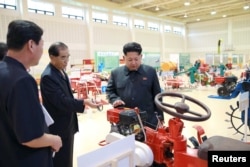 North Korean leader Kim Jong Un visits a farm machine exhibition in this undated photo released by North Korea's Korean Central News Agency (KCNA) in Pyongyang, Aug. 6, 2015.