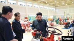 North Korean leader Kim Jong Un visits a farm machine exhibition in this undated photo released by North Korea's Korean Central News Agency (KCNA) in Pyongyang, Aug. 6, 2015. 