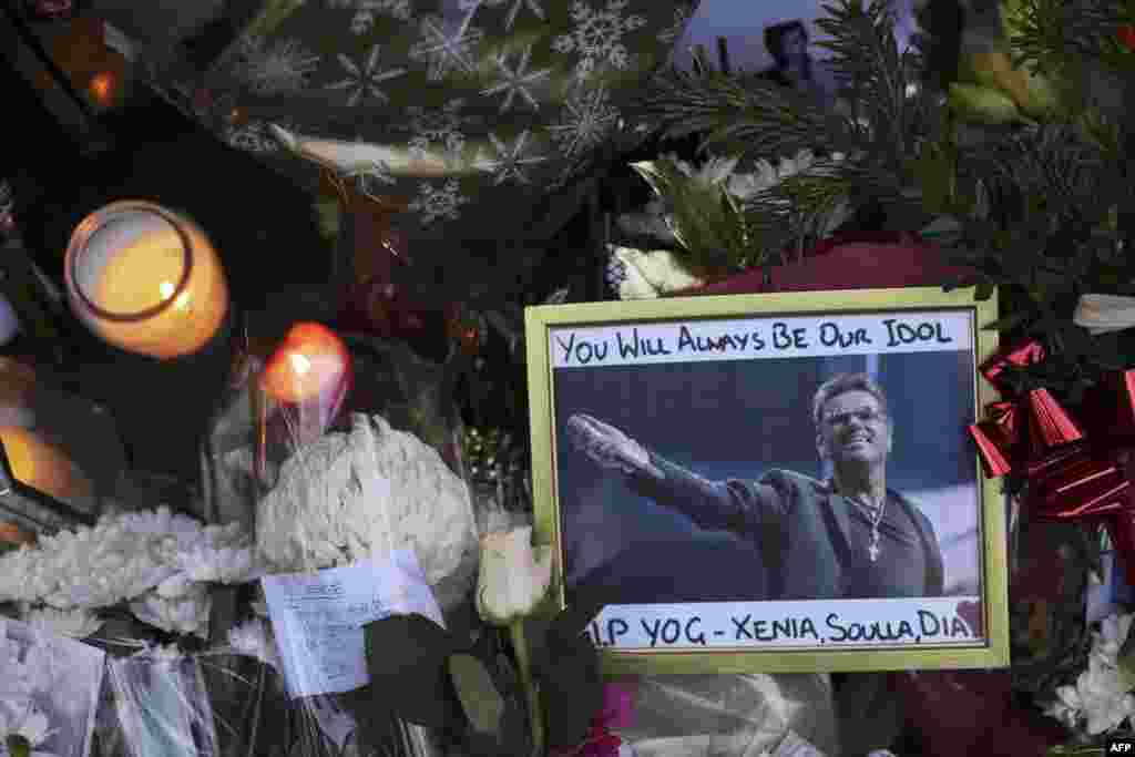 A photograph of British singer George Michael is seen among floral tributes and candles outside his north London home, Dec. 26, 2016, after news of the singer's death broke. The British pop superstar, who rose to fame with the duo Wham! and a string of smash hits including "Last Christmas," died, aged 53, of apparent heart failure on Christmas Day at his home in Goring, a village on the River Thames in Oxfordshire, west of London, after an award-winning career spanning more than three decades. 