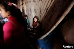 Internally displaced children attend a class inside a cave in the rebel-controlled village of Tramla, in Idlib province, Syria, March 27, 2016.