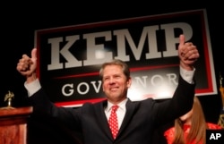 Georgia Republican gubernatorial candidate Brian Kemp gives a thumbs-up to supporters in Athens, Ga., Nov. 7, 2018.