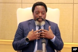 FILE - Democratic Republic of Congo's President Joseph Kabila speaks during an interview by the Associated Press at the Nation's Palace in Kinshasa, Dec. 9, 2018.