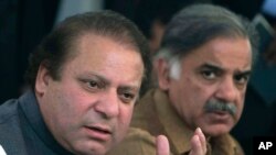 FILE - In this Feb. 17, 2008 file photo, Pakistan's Prime Minister Nawaz Sharif, left, and his brother Shahbaz Sharif address a news conference in Lahore, Pakistan. 