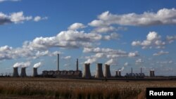 FILE - Smoke rises from the cooling towers of a coal-fired power plant operated by Eskom in South Africa Taken May 20, 2018. 