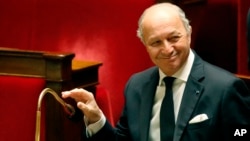 French Foreign Minister Laurent Fabius, smiles during a debate on the recognition of the Palestinian at the French Parliament in Paris, Nov. 28, 2014. 