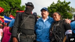 El presidente de Nicaragua, Daniel Ortega, posa con agentes de policía en Masaya, el viernes 13 de abril de 2018. La policía nacional y fuerzas paramilitares tienen sitiada la ciudad del sureste del país el marte 17 de julio de 2018. Foto: AP/Cristóbal Venegas.