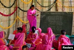 Sheetal Prakash More (R), a 30-year-old teacher, teaches at Aajibaichi Shaala (Grandmothers' School) in Fangane village, India, Feb. 15, 2017.