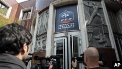 Journalists film outside the French soccer federation headquarters in Paris, May 6, 2011