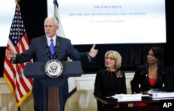 Mike Pence speaks at education meeting, as Educaton Secretary Betsy DeVos (center) watches.