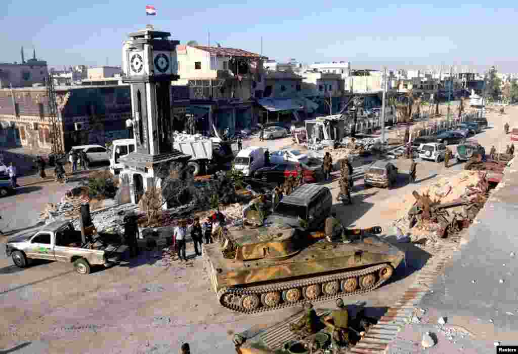 Pro-government fighters and tanks in Qusair, after the Syrian army took control of the city from rebel fighters, June 5, 2013. 