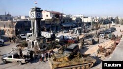 Soldiers loyal to the Syrian regime with their military tanks in Qusair, after the Syrian army took control of the city from rebel fighters, June 5, 2013. 