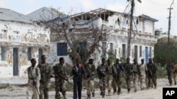 Somali government soldiers patrol after fighting against Islamist insurgents al Shabaab in Suqa Holaha village of Horiwaa district, northern Mogadishu, March 3, 2012.