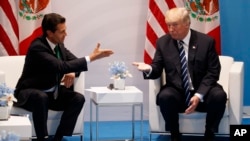FILE - President Donald Trump meets with Mexican President Enrique Pena Nieto at the G20 Summit, July 7, 2017, in Hamburg.