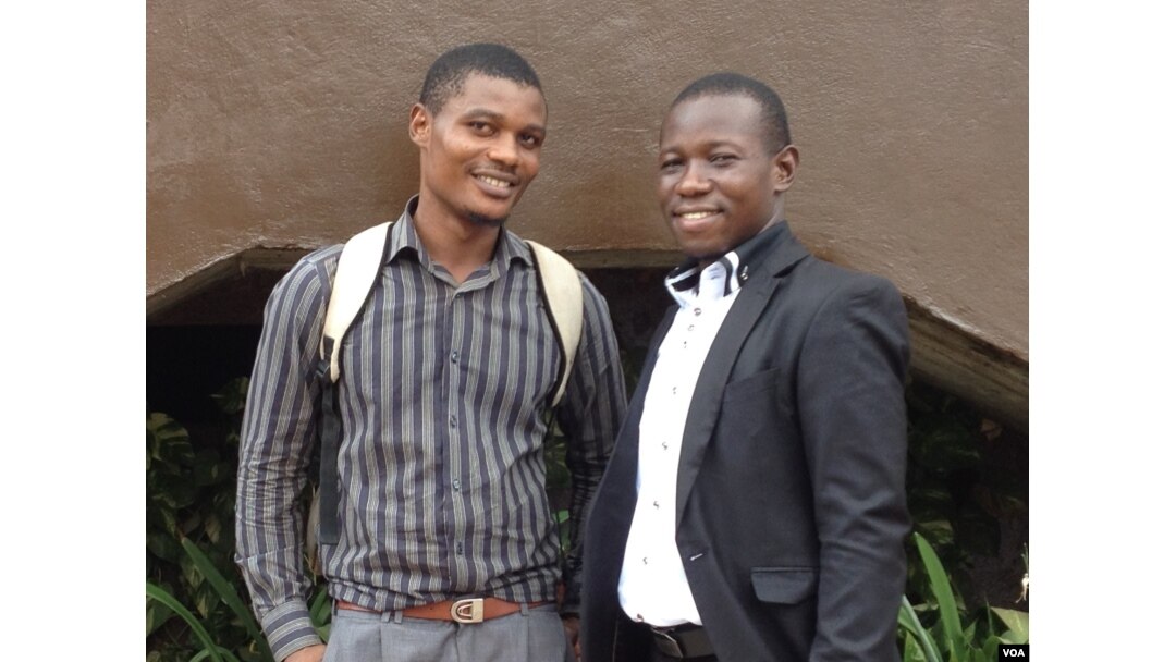 Mustapha Kallon stands with fellow survivor Brima Bockarie in Freetown, Sierra Leone, April 6, 2017. Kallon said that had he not reached out to others, he might not have been able to get through his depression. (N. DeVries/VOA)