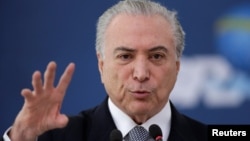 Brazil's President Michel Temer gestures during the launch of the new financing line of Bank Caixa Economica Federal in Brasilia, Nov. 24, 2016. On Dec. 1, 2016, with many governors struggling to pay pensioners and employees, Temer was forced to soften his austerity measures. 
