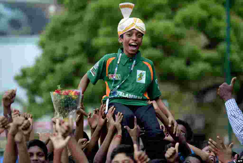 Indian chess prodigy Rameshbabu Praggnanandhaa, 12, celebrates upon arrival back to his school in Chennai after becoming the world&#39;s second-youngest chess grandmaster ever.