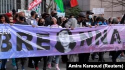 People attend a rally to mark one year since police officers shot and killed Breonna Taylor when they entered her home, in Louisville, Kentucky, U.S., March 13,2021. 