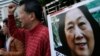 FILE - Anti-Beijing protesters hold picture of veteran Chinese journalist Gao Yu during a rally outside Chinese central government's liaison office in Hong Kong.