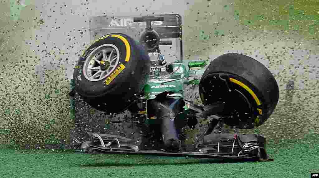 The car of Caterham-Renault driver Kamui Kobayashi of Japan veers off the track during an accident at the start of the Formula One Australian Grand Prix in Melbourne, Australia, March 16, 2014.