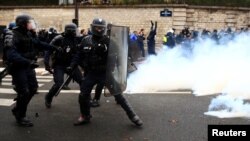 French riot police take position during clashes with French ambulance drivers as part of a demonstration at the Place de la Concorde in Paris, France, Dec. 3, 2018.