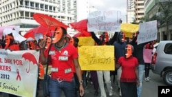 Masked sex workers march through the streets to demand access to government services, in Nairobi, Kenya, March 6, 2012.