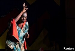 A storyteller gestures with his fingers splayed above his head as he tells the modern fable about why chickens don't fly during the Re-imagined Storytelling Festival in Nairobi, Kenya, Dec.15, 2018.