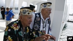 Pearl Harbor survivors George Richard (L) and Charlie Boswell talk about where they were on December 7, 1941 as they tour the Arizona Memorial at the World War II Valor in the Pacific National Monument in Honolulu, Hawaii December 5, 2011.