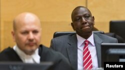 Kenya's Deputy President William Ruto (R) reacts as he sits in the courtroom before his trial at the ICC in The Hague in this September 10, 2013, file photo.