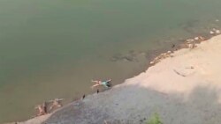 This frame grab from video provided by KK Productions shows bodies lying along the river in Ghazipur district in Uttar Pradesh state India, Tuesday, May 11, 2021.