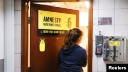 A woman enters the Amnesty International Hong Kong office, after its announcement to close citing China-imposed national security law, in Hong Kong, China Oct. 25, 2021. 